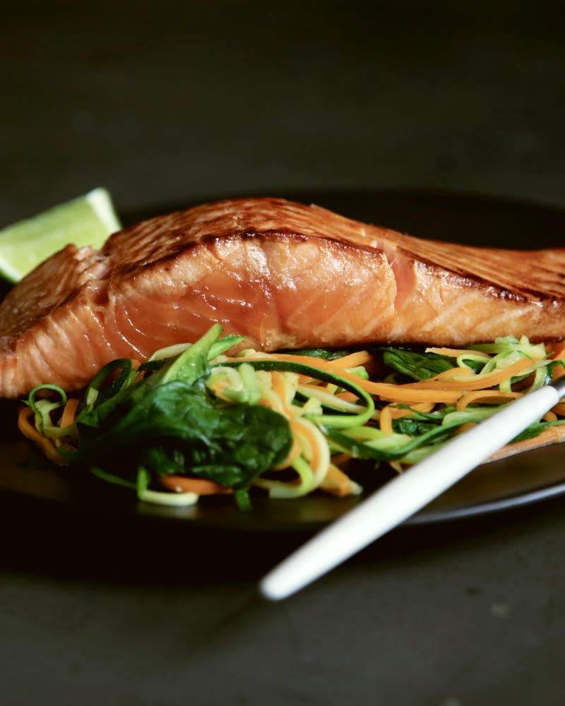 Seared fish fillet plated with greens